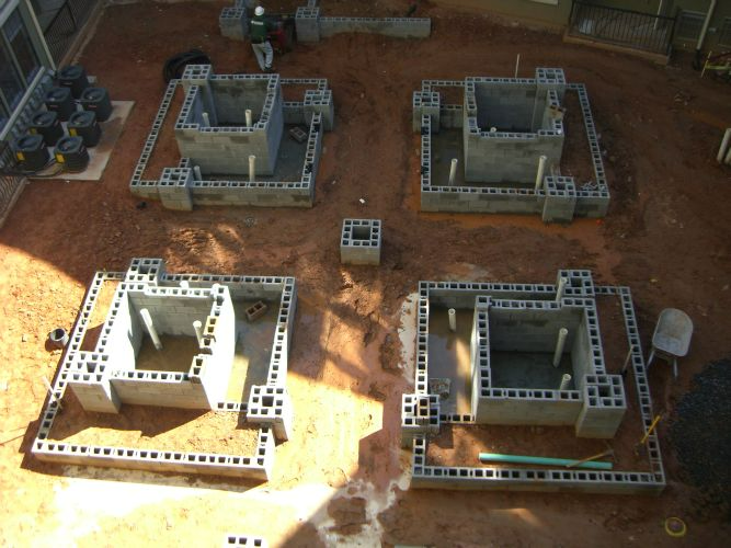 a group of concrete blocks sitting on top of a dirt ground