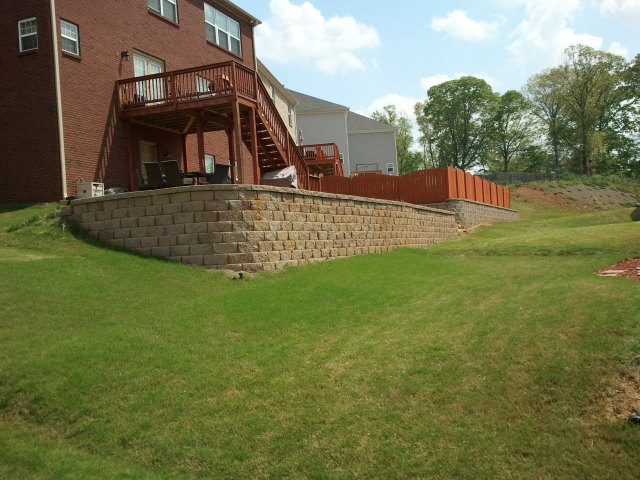 a house with a deck and stairs in the backyard .