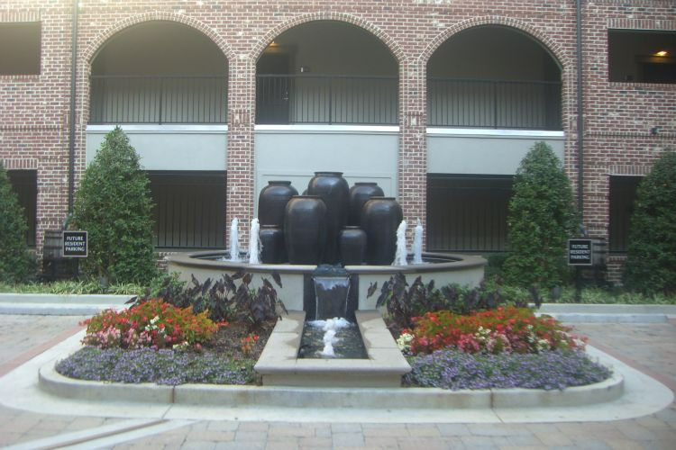 a brick building with a fountain in front of it.