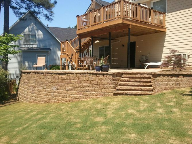 a house with a deck and stairs in the backyard