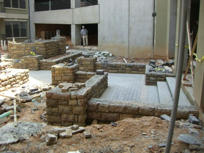 a brick wall is being built in front of a building