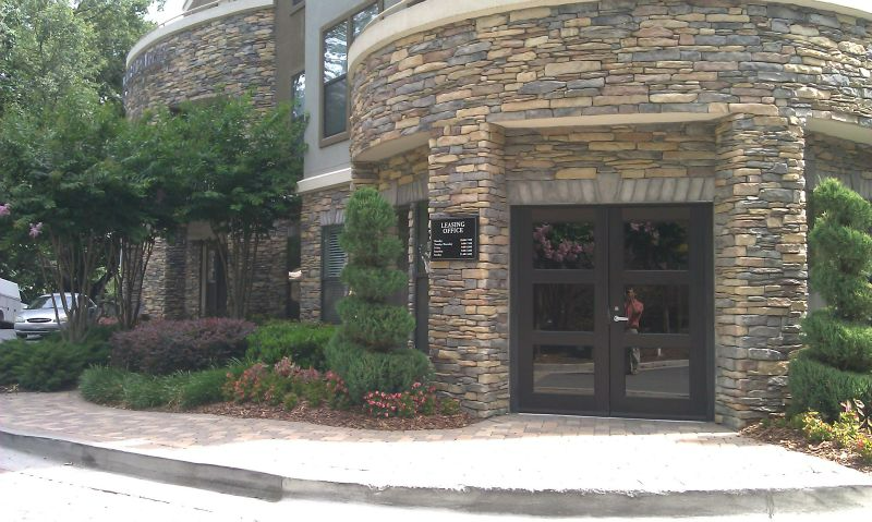 a building with a stone facade and a black door.