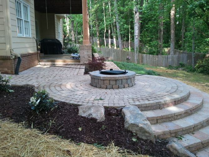there is a fire pit in the middle of the patio .