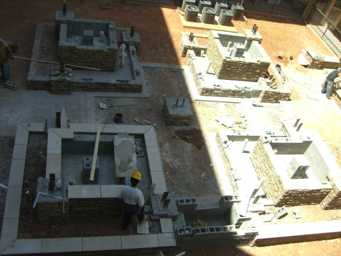 a man in a yellow hard hat is working on a construction site