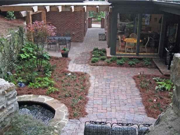 a brick patio with a waterfall in the middle of it
