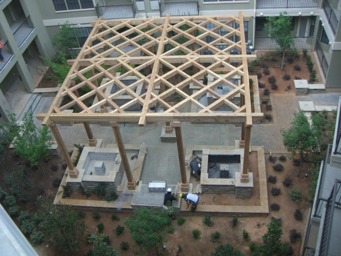 an aerial view of a pergola in a courtyard