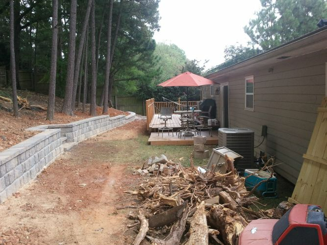 a house with a deck and umbrellas in the backyard