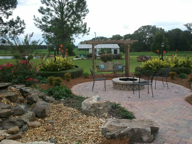a fire pit sits in the middle of a garden