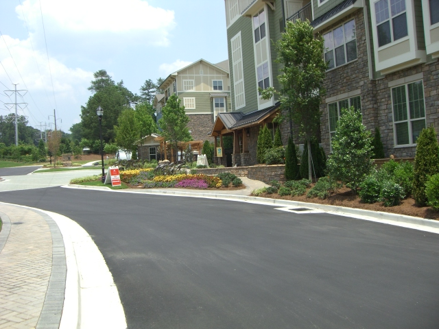 a residential street with a building in the background