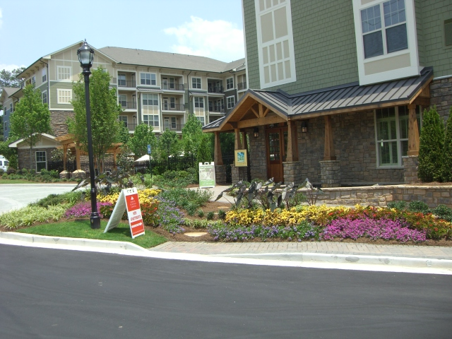 a for sale sign is in front of a building