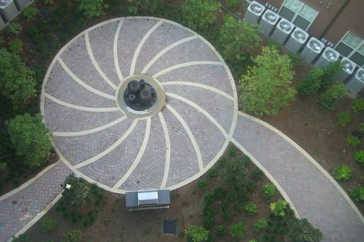 an aerial view of a circular walkway surrounded by trees