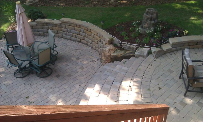 a patio with a table and chairs and an umbrella