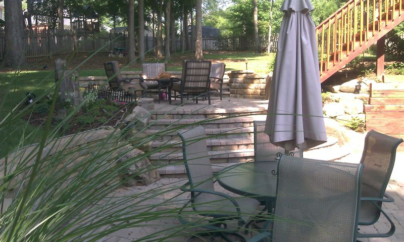 a patio with a table and chairs and an umbrella
