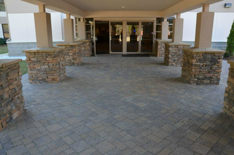 a brick walkway leading to the entrance of a building
