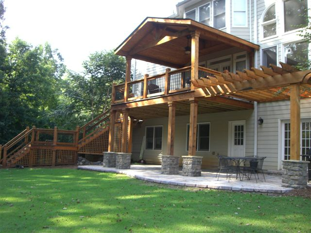 a large house with a large deck and a pergola