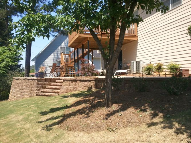 a house with a deck and stairs in the backyard .