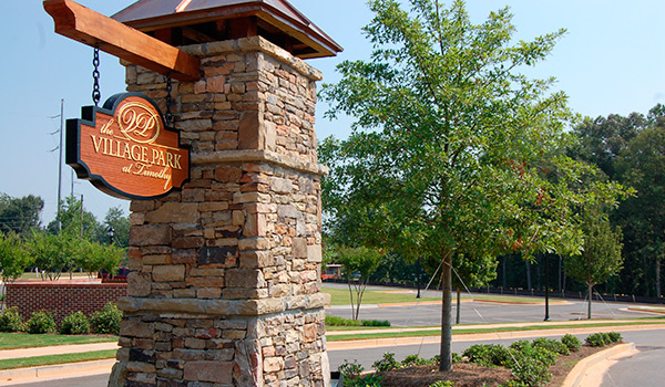 a stone pillar with a sign on it that says valley park .