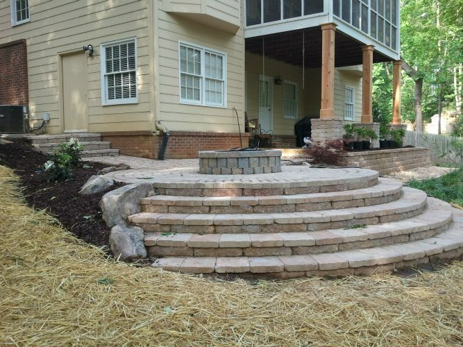 a house with a screened in porch and stairs leading up to it .