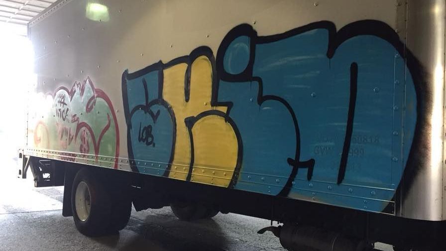 A truck with graffiti on the side of it