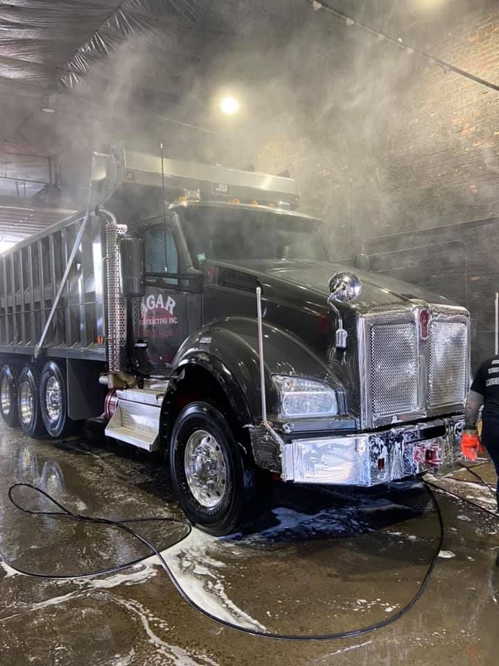 A dump truck is being washed
