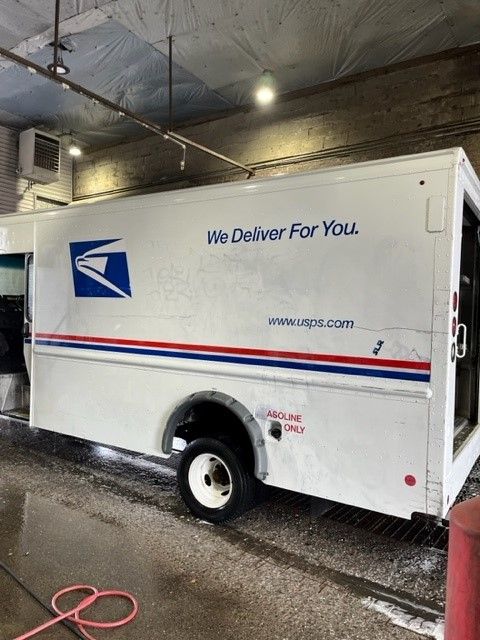 A white truck undergoing graffiti removal