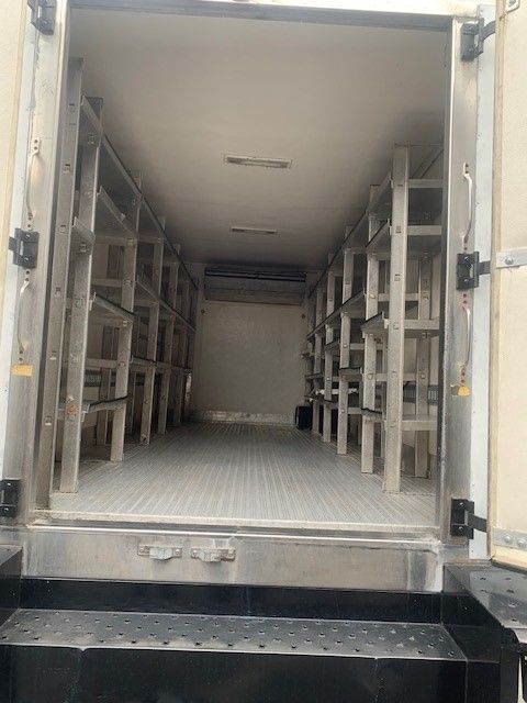 The inside of a refrigerated truck with shelves