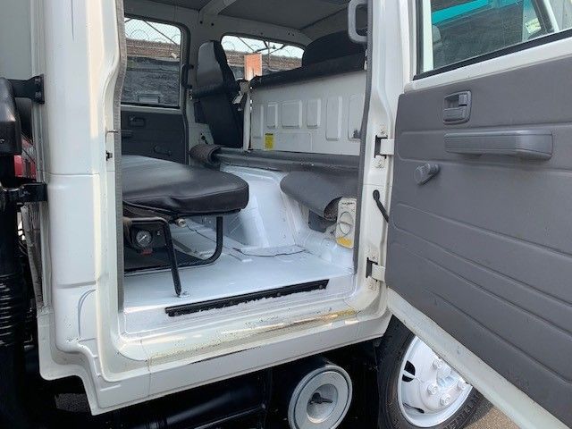 The inside of a white truck with the door open