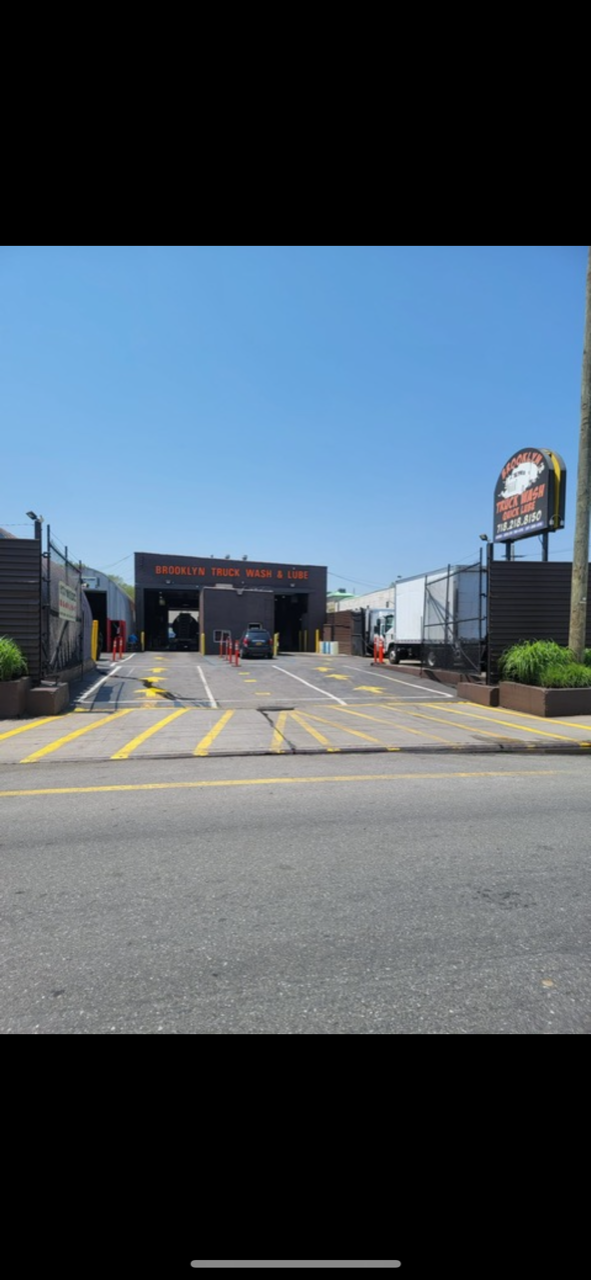 A truck wash building with a lot of cars parked in front of it