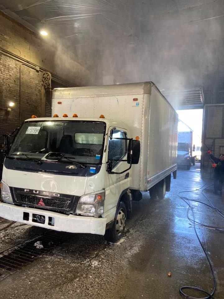 A white truck is being washed