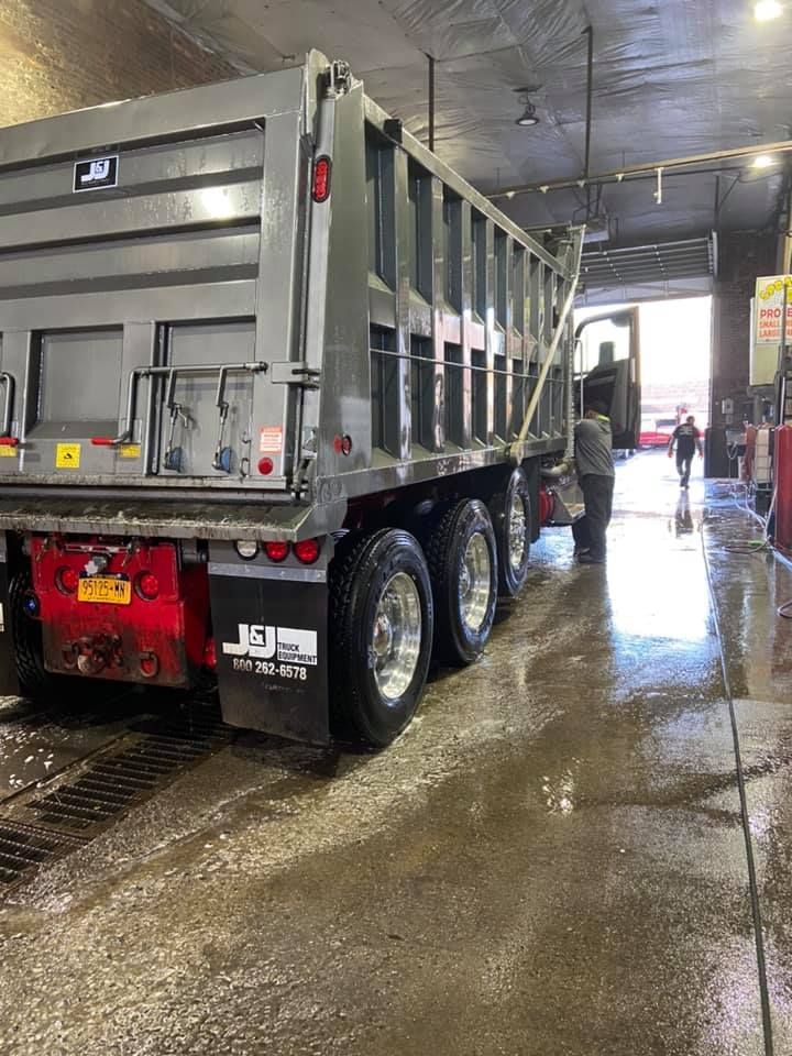 A dump truck is being washed