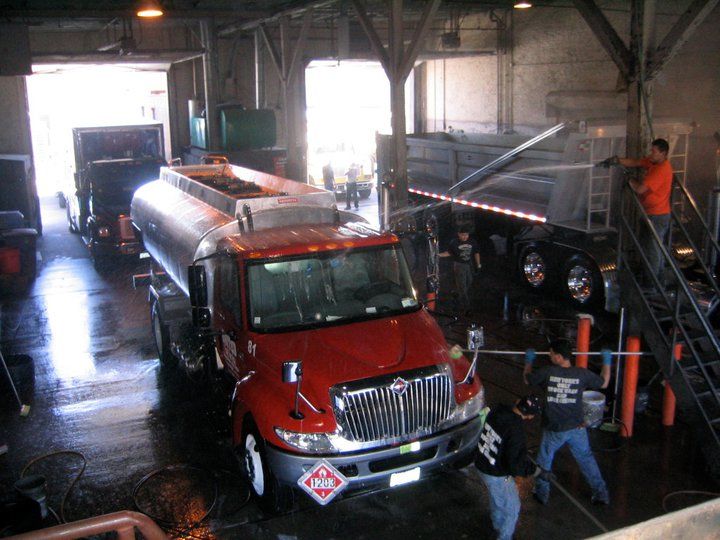 A red tanker truck being washed