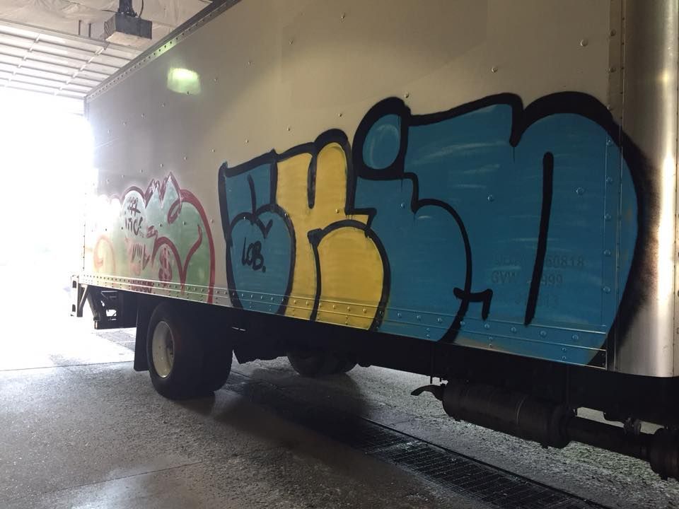 A truck with graffiti on the side of it