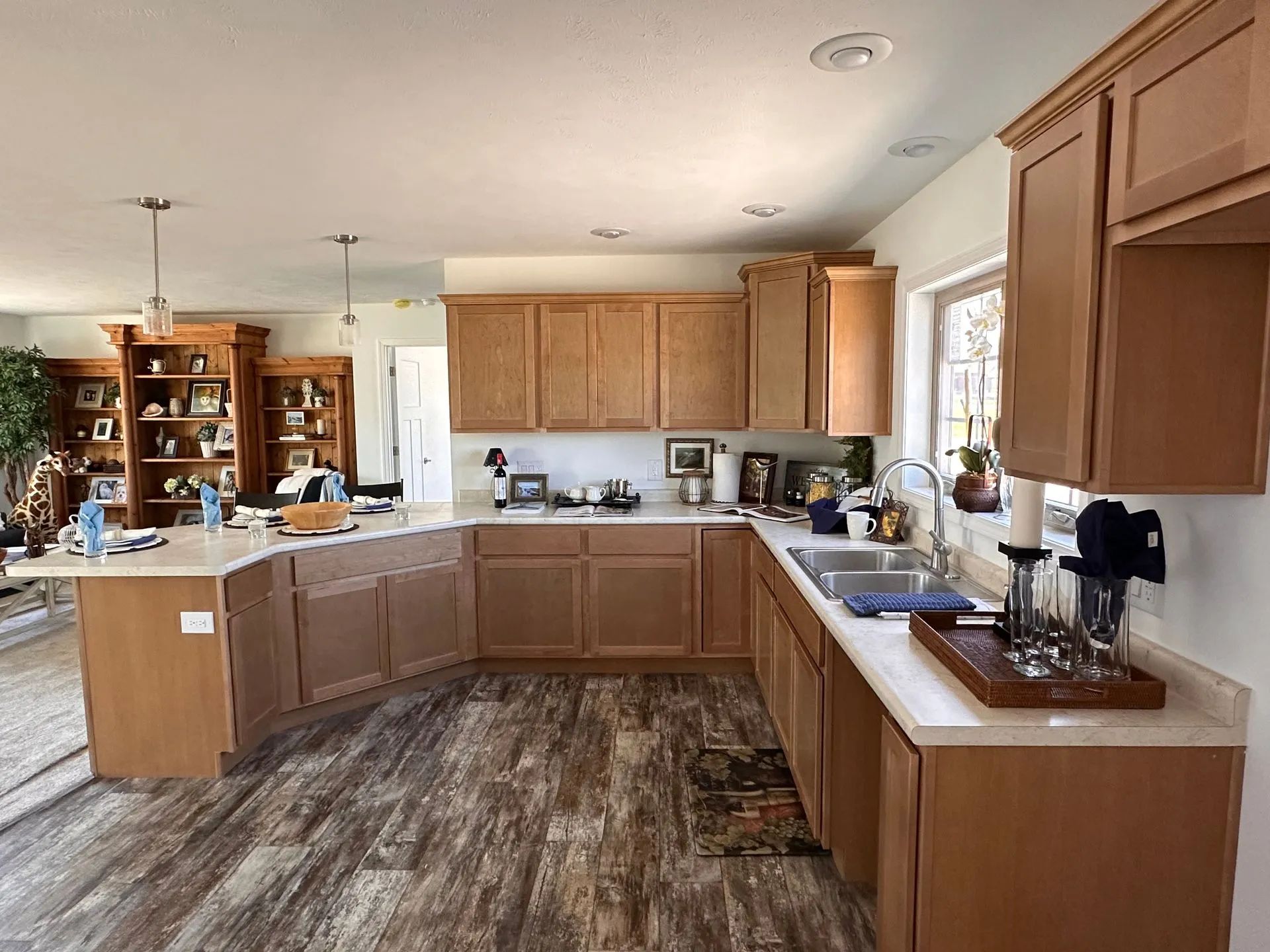 Spacious kitchen with wood cabinets, center island, and window over the sink, lit by natural light