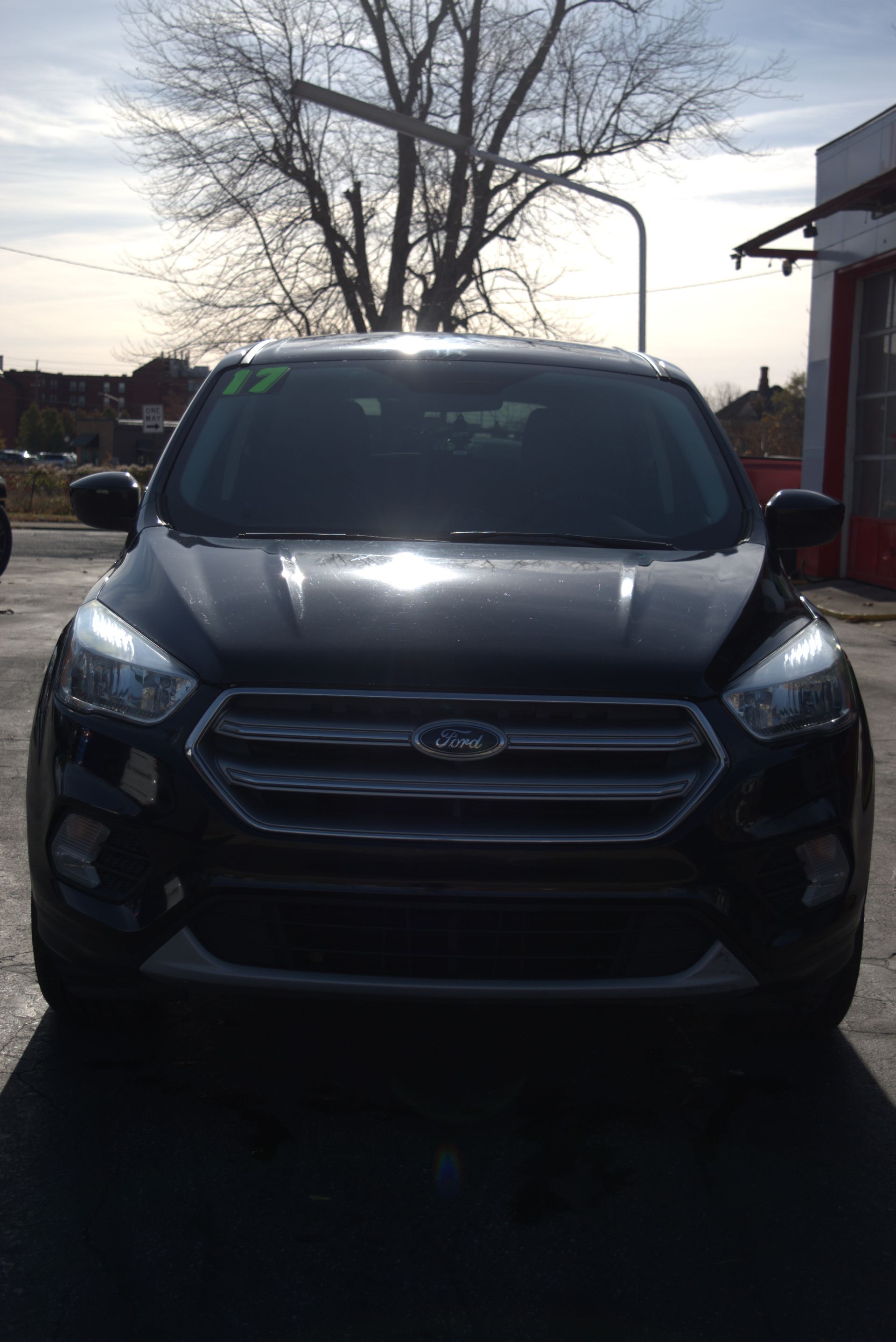 A white car is parked in a parking lot