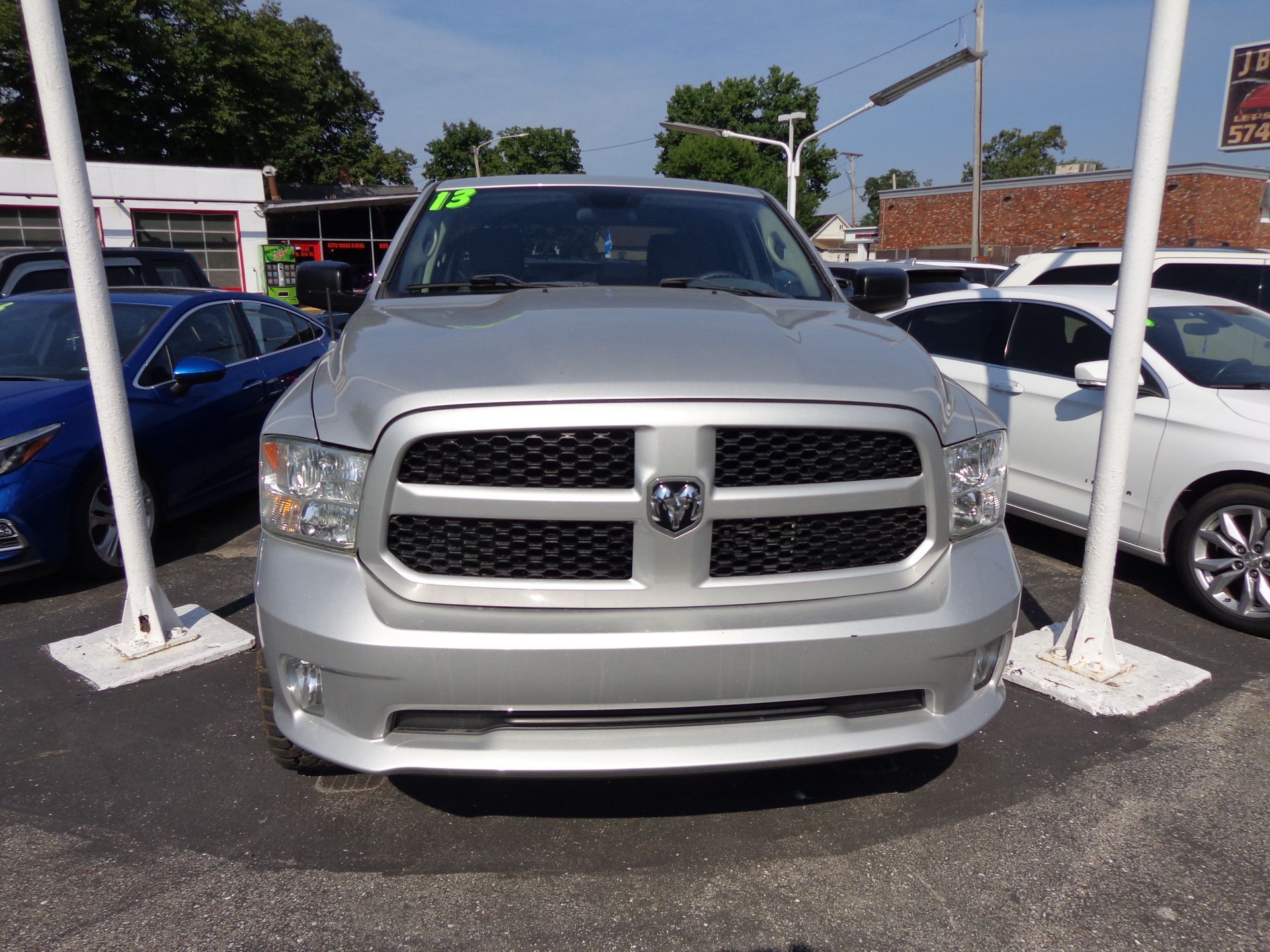 A white car is parked in a parking lot