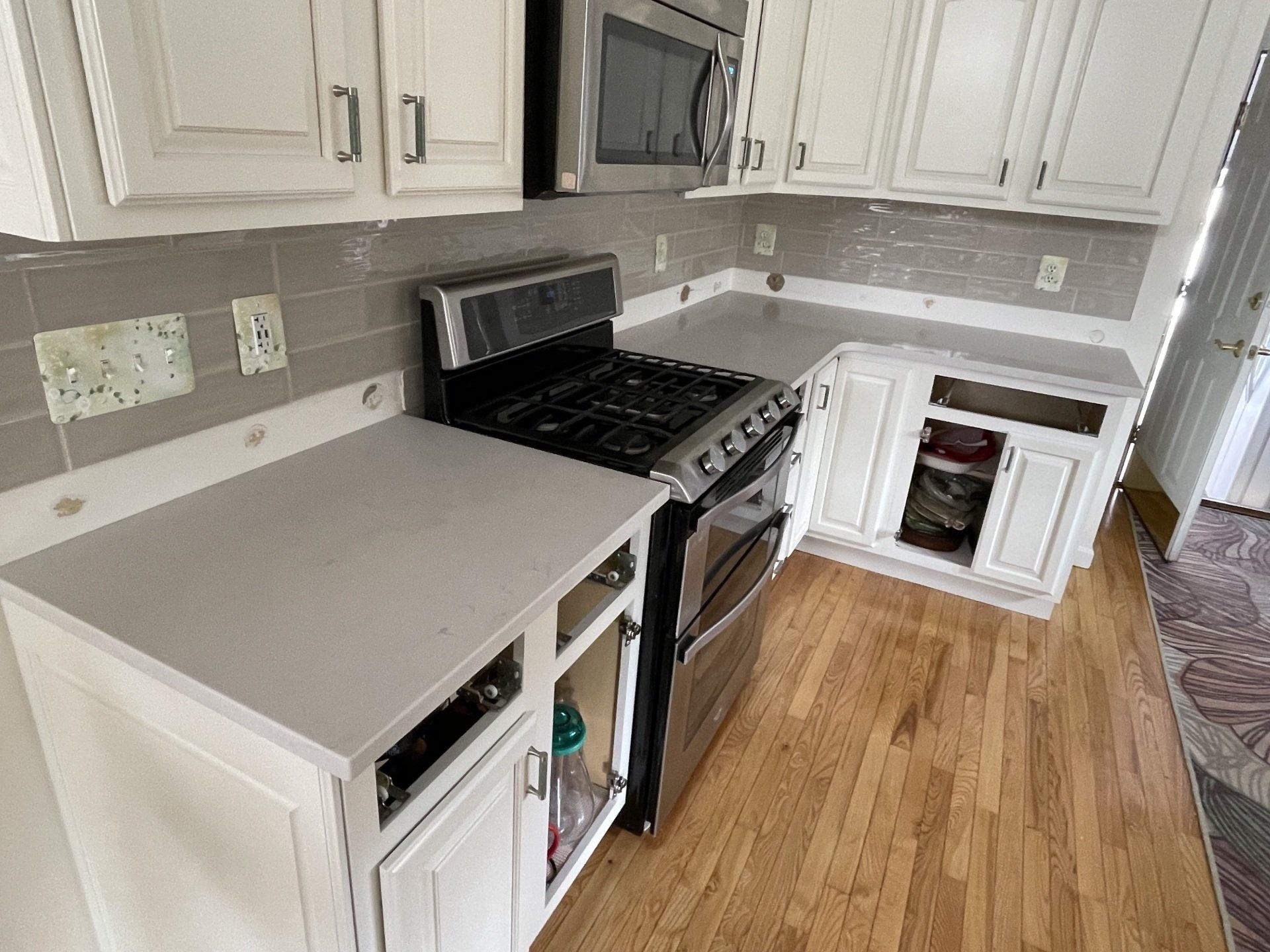 Kitchen with quartz countertop and black stove