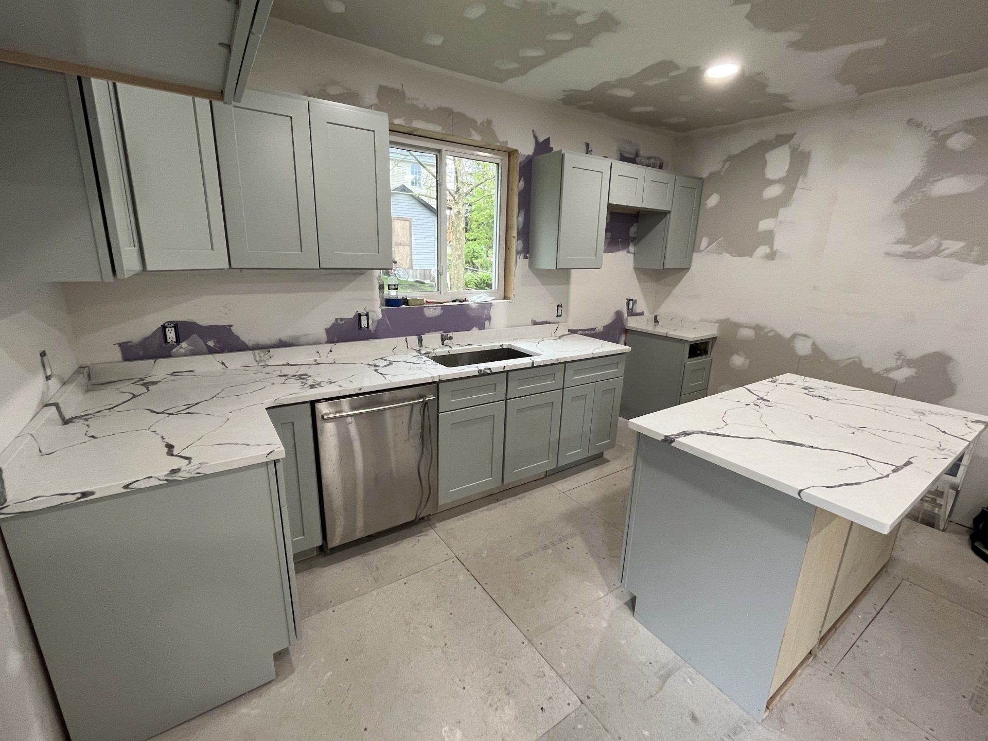 Kitchen with quartz countertop and black stove