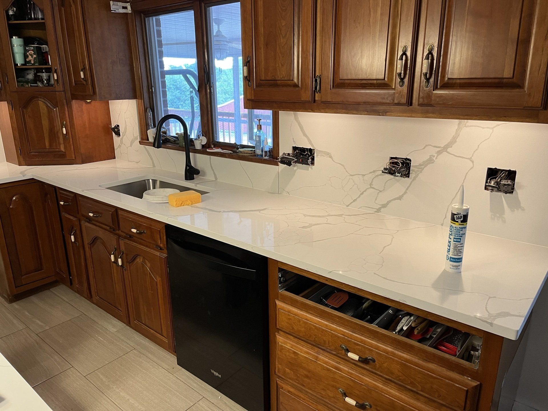 Kitchen with quartz countertop and wooden cabinets