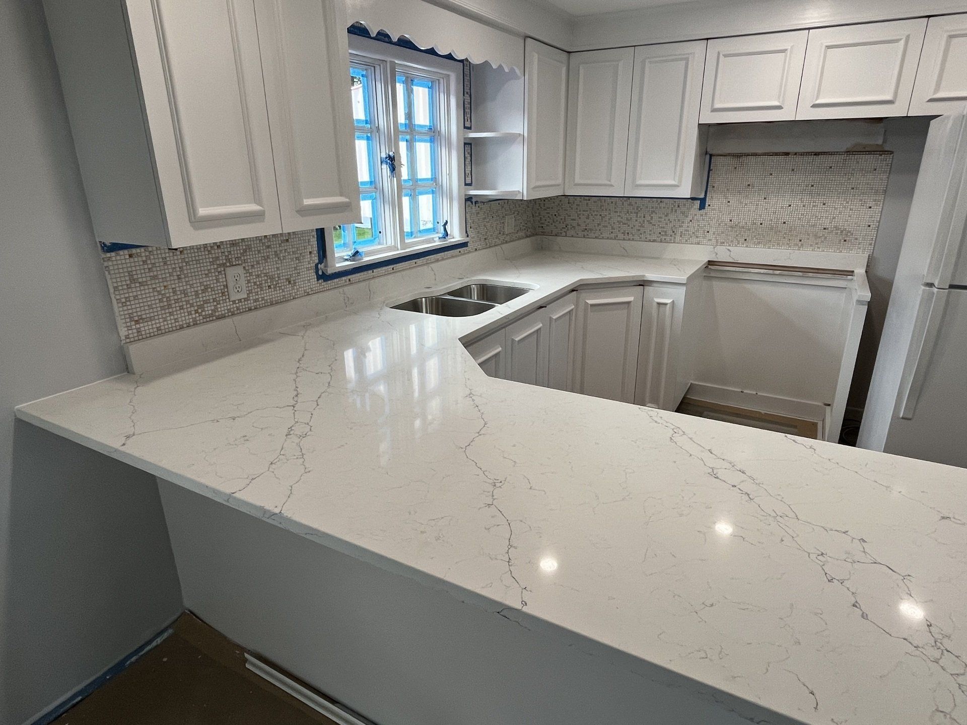 Kitchen with white countertops and walls