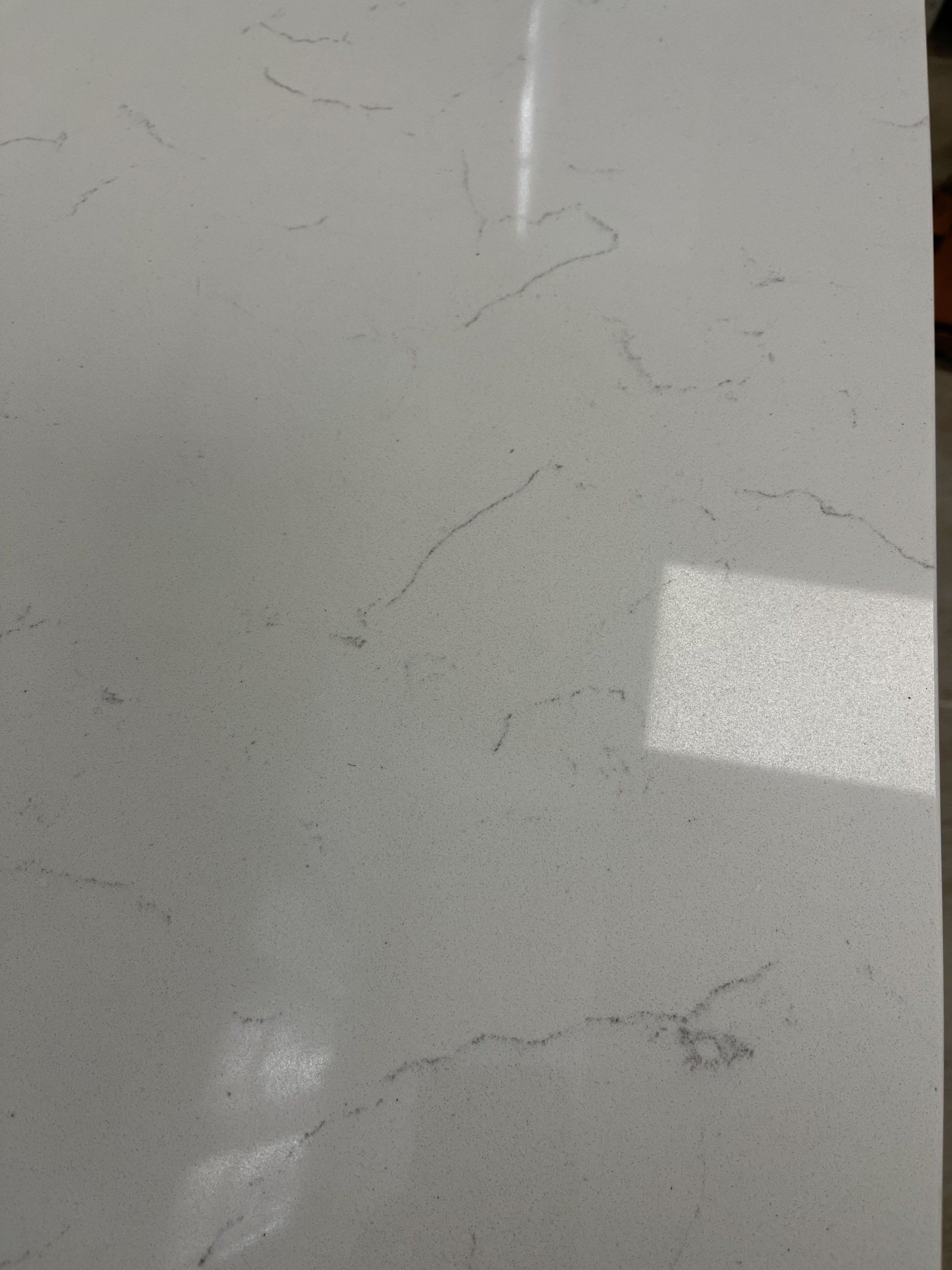 A close up of a white countertop with a marble texture