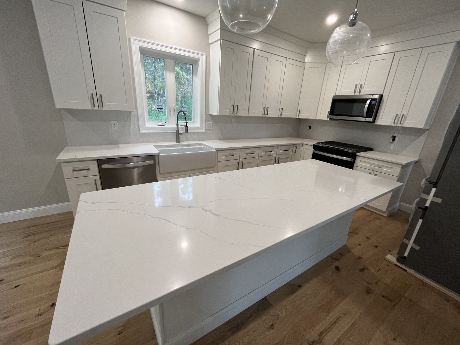 There is a large quartz island in the middle of the kitchen