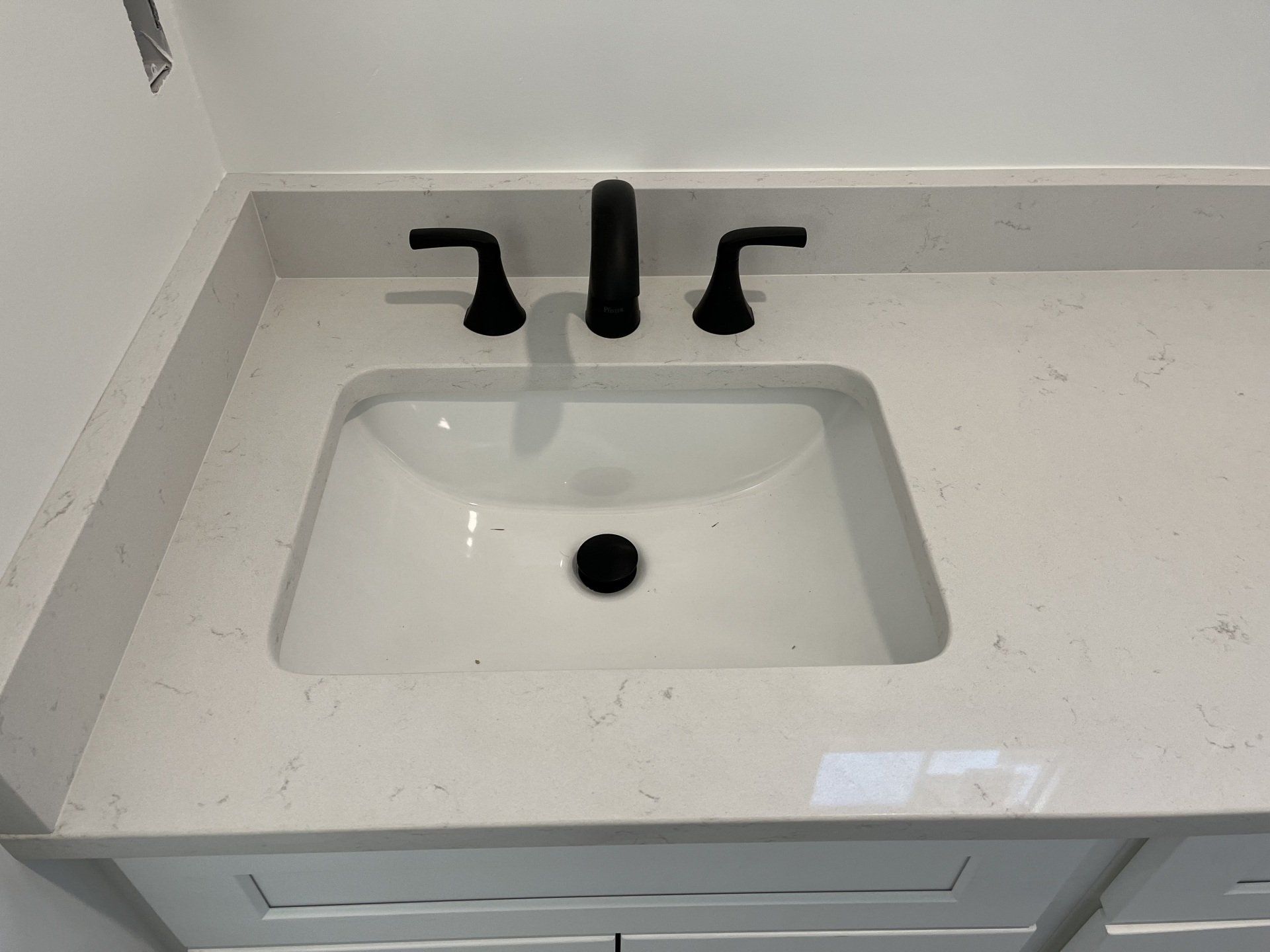 Bathroom sink with black faucet