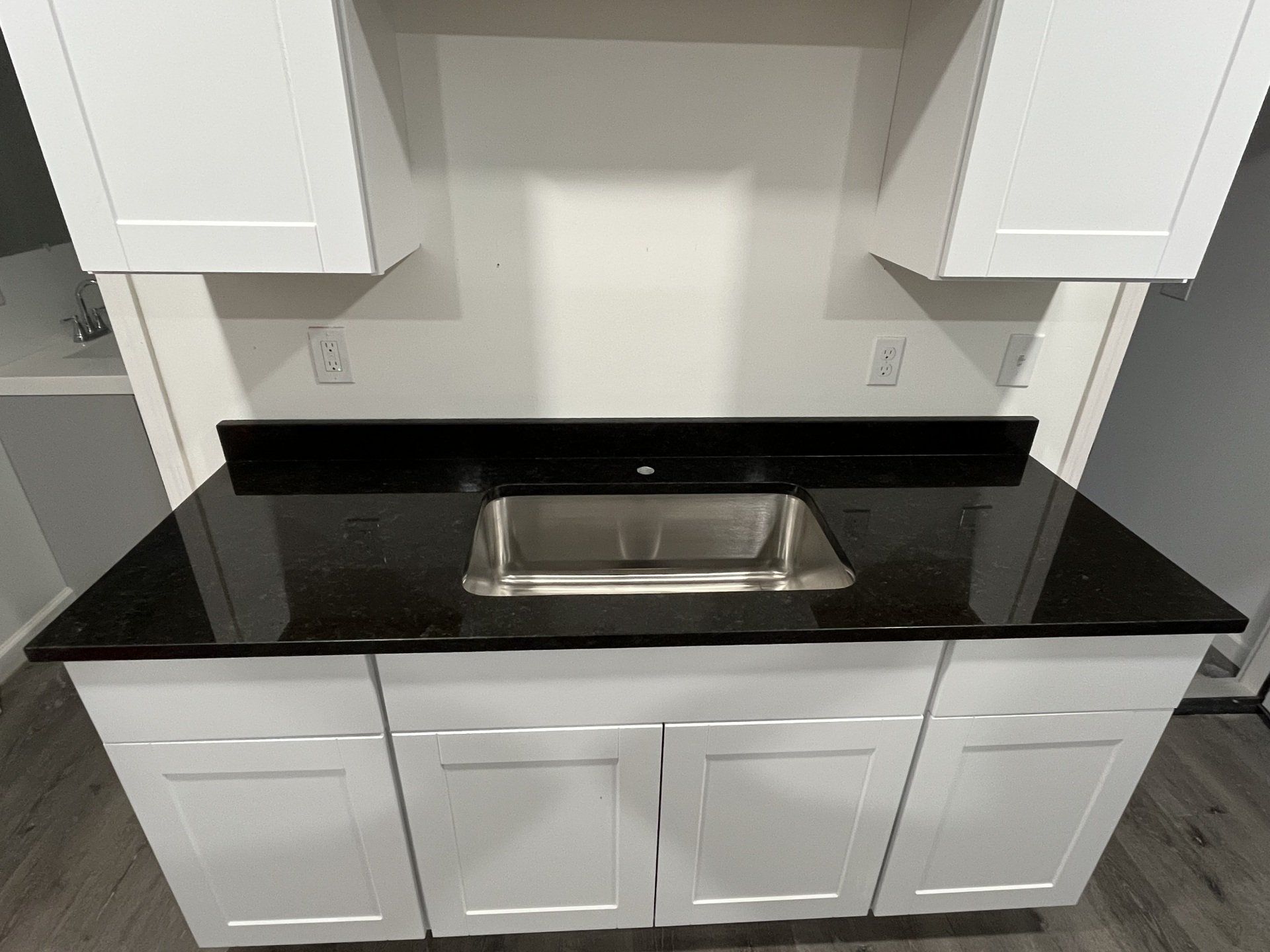 Kitchen with sink and black countertop