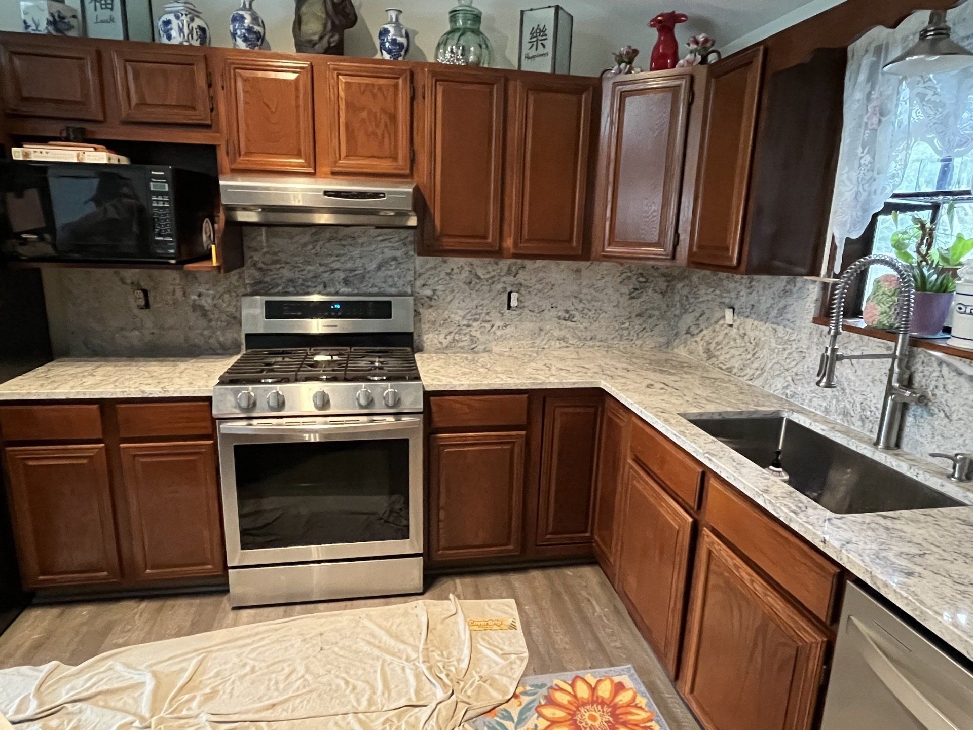A kitchen with stainless steel appliances and wooden cabinets