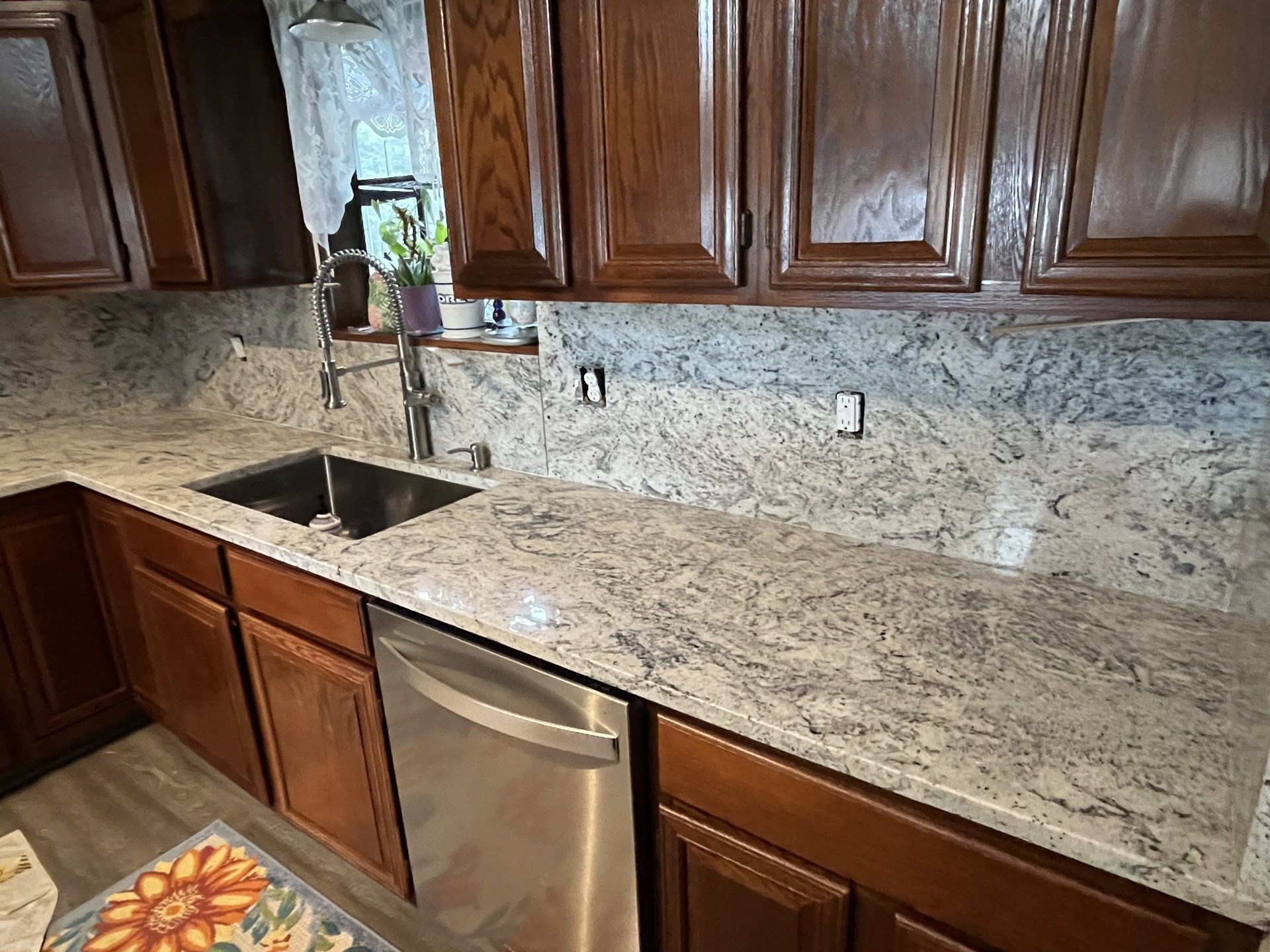 Kitchen with gray and white granite countertop