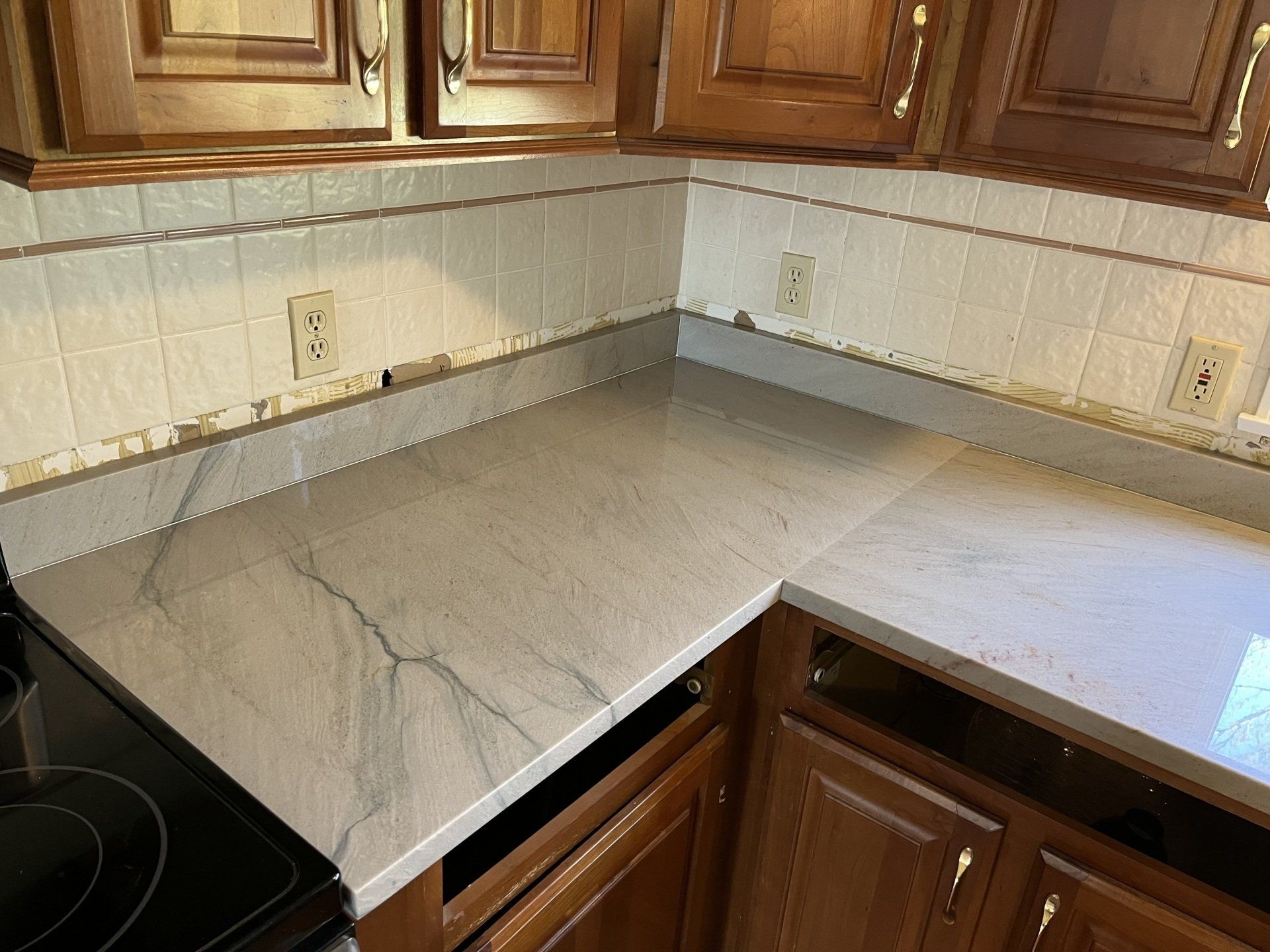 A kitchen with wooden cabinets and a quartzite countertop