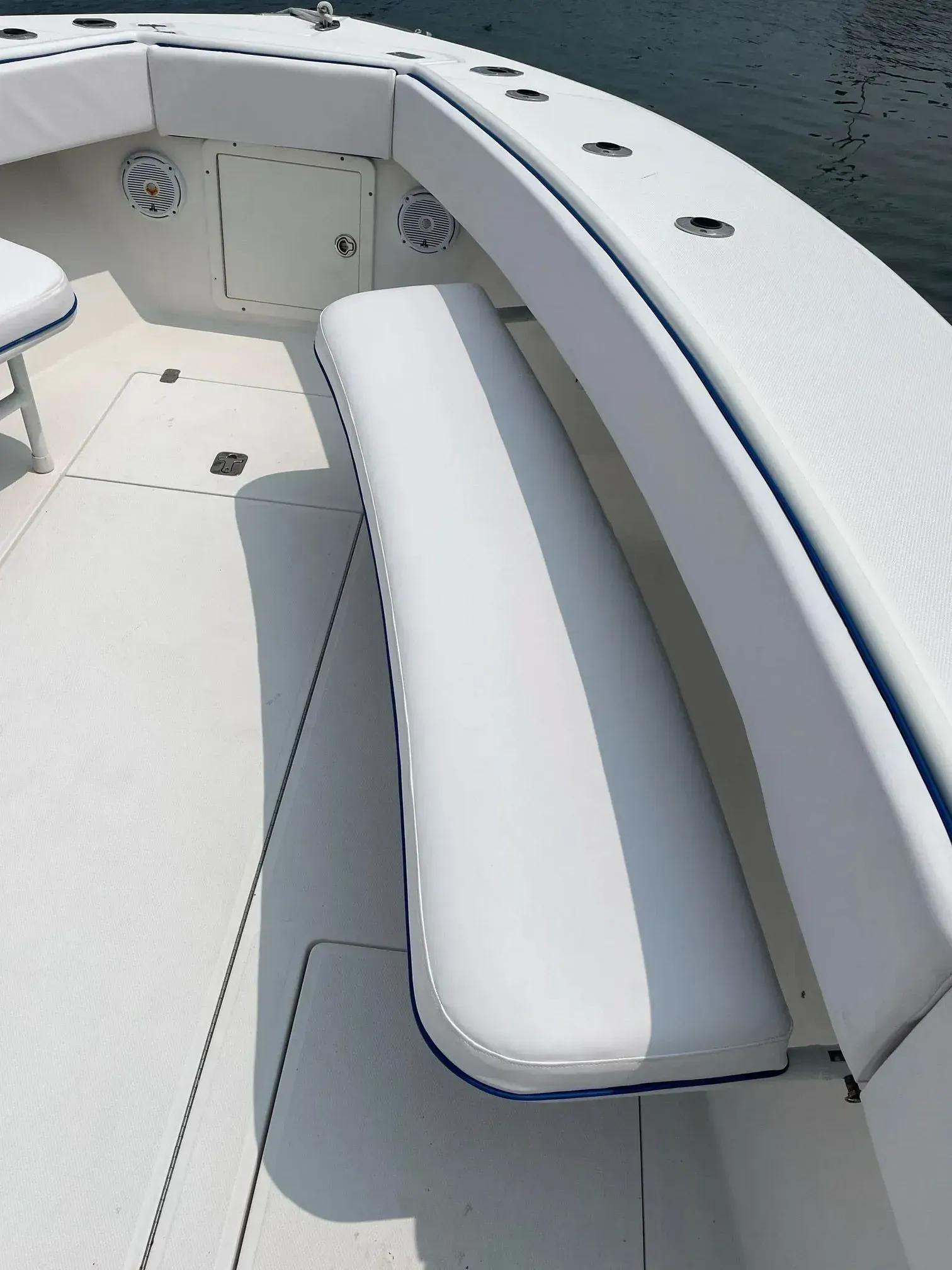 White boat interior with cushioned seating and blue trim.