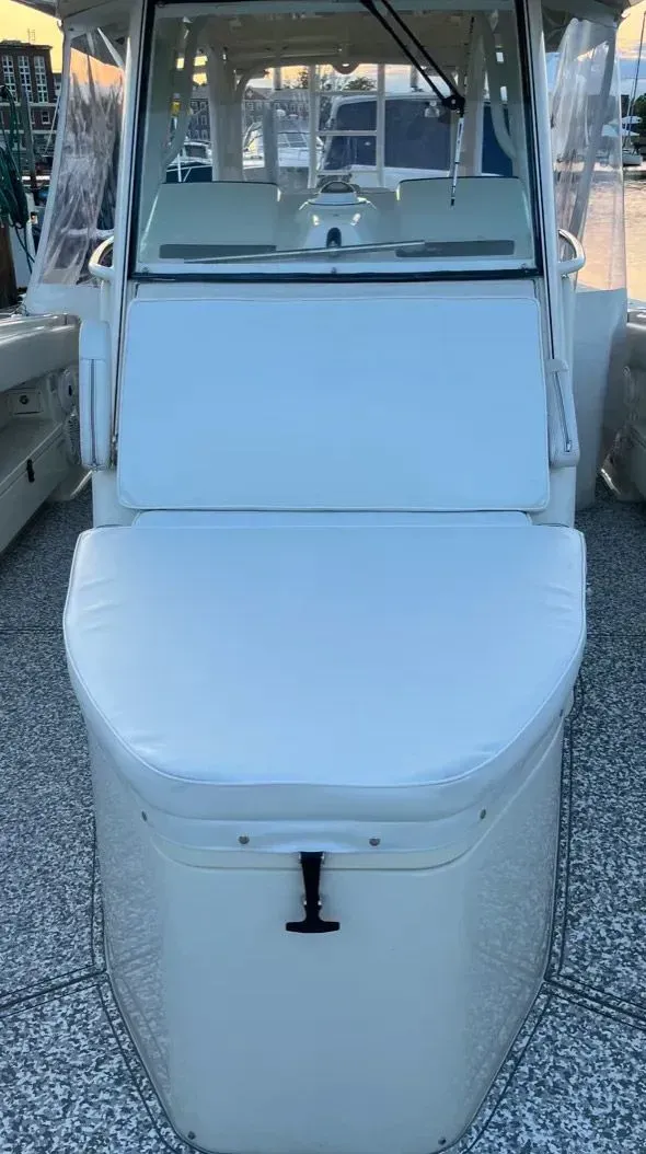White boat with cushioned seating; windshield.