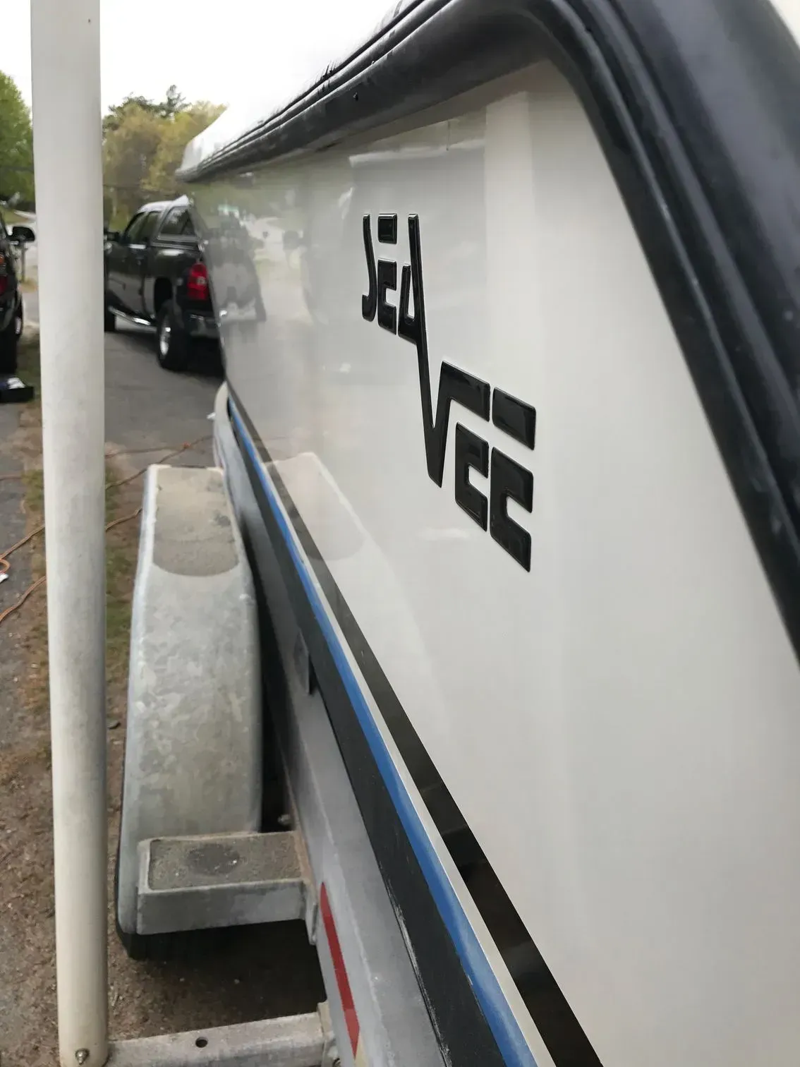 Side view of a white boat on a trailer with 