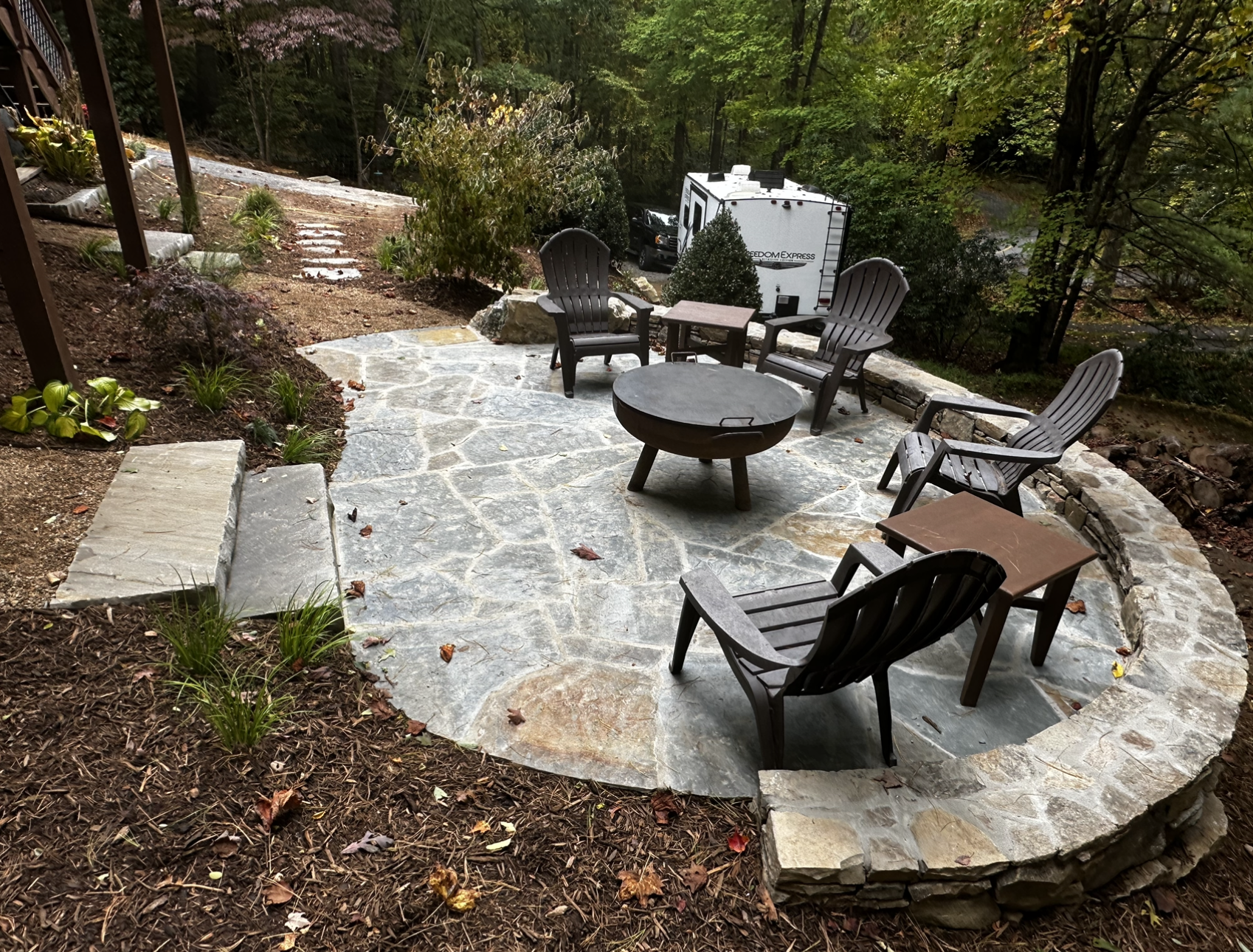 There is a fire pit in the middle of the patio.